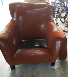 Fabulous but very smelly chair covered with baking soda airing out in my car port.