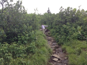 My daughter on a slippery, rocky path on a a day so overcast there was not much of a view.