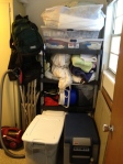 Laundry room also acting as linen closet and camping  equipment storage.